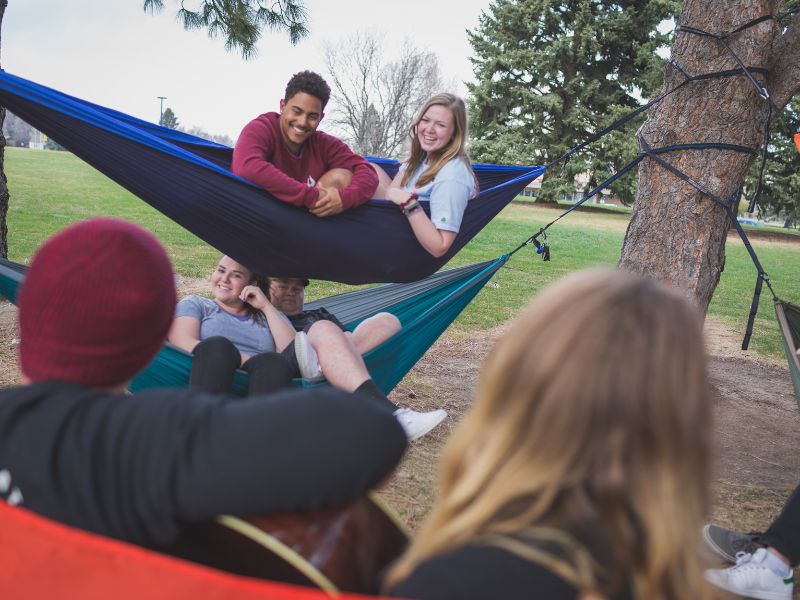 Students lounge in a hammock