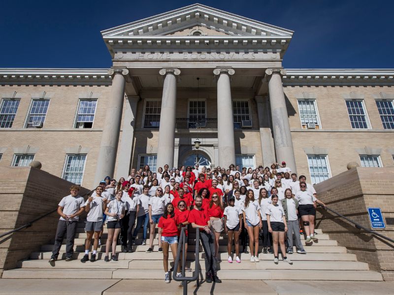 A large group of Lead On students and employees poses for a group photo on campus