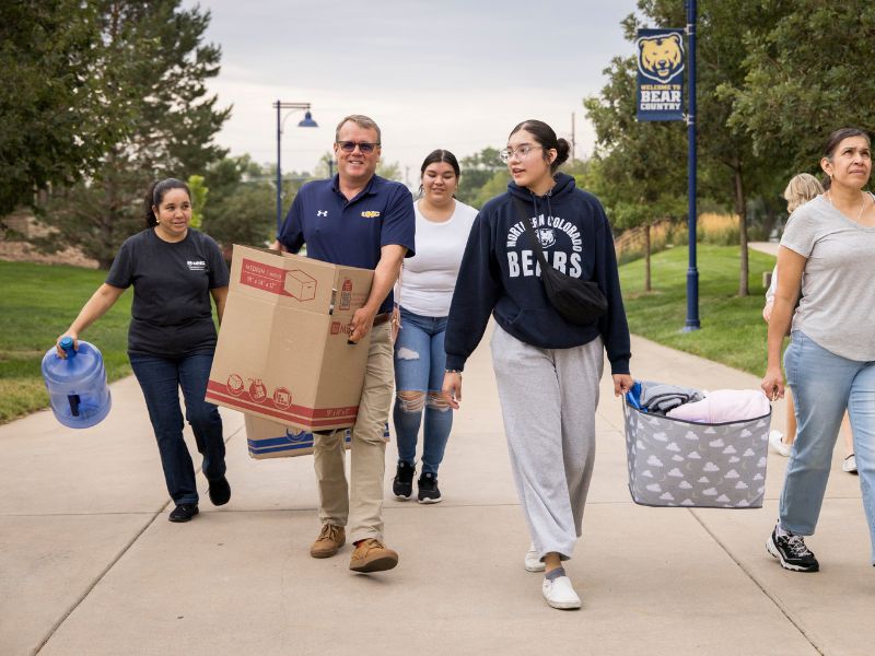 UNC President, Andy Fienstein, helps a student move in
