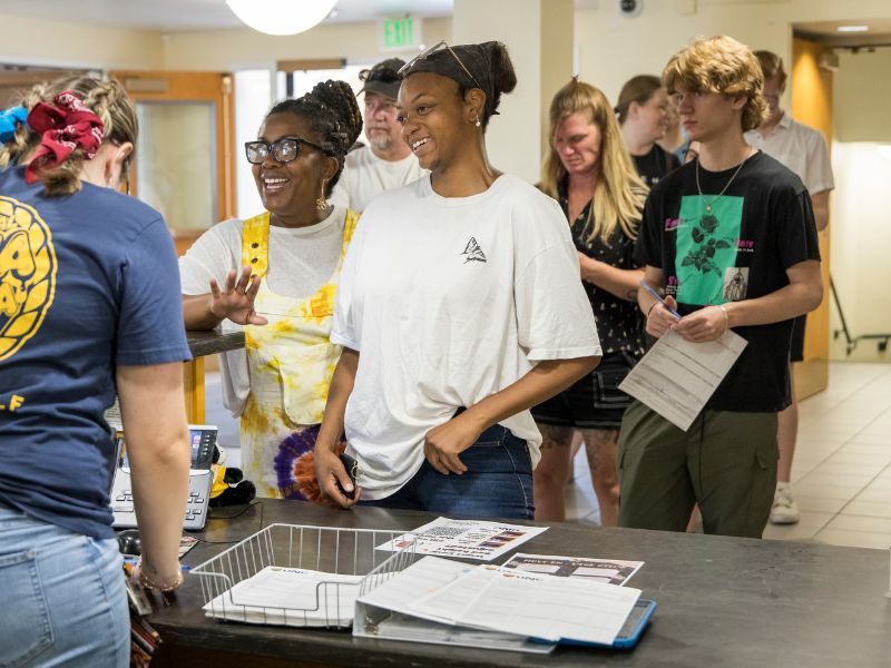 Students checking in at a desk
