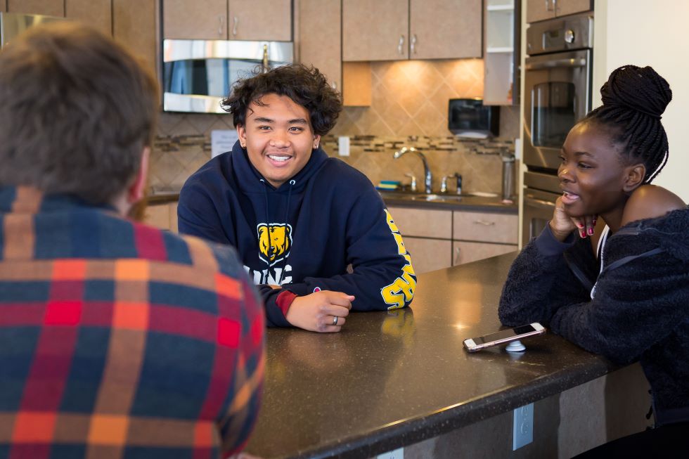 Students chatting in kitchen