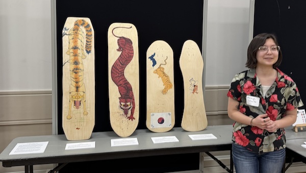 Student presenting visual art project at 2025 Student Showcase.