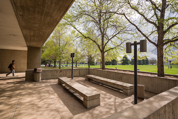 Student walking in front of Candelaria hall