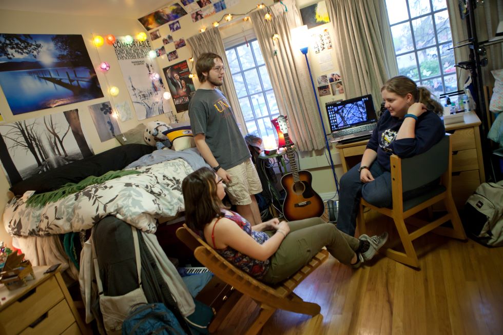 Three students chatting in room