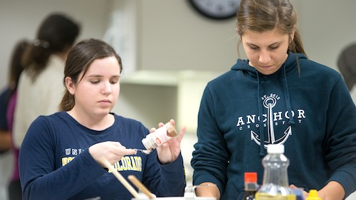Two female students cooking in nutrition class