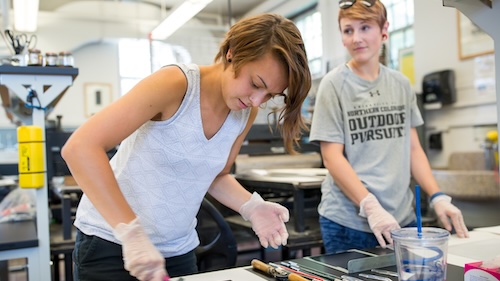 Two female students in printmaking class