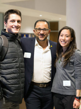 Three smiling graduate students posing for the camera.