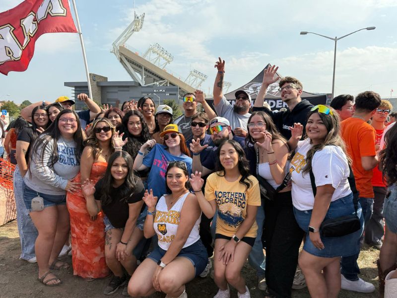 Members of FSL pose for a group photo at a tailgating event