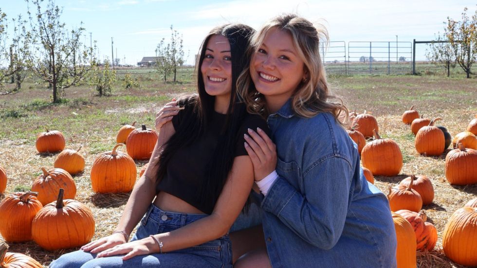 Members of Panhellenic poses for a photo in a pumpkin patch