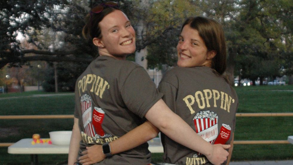 AOII members pose for a photo showing off their t-shirts at a movie event