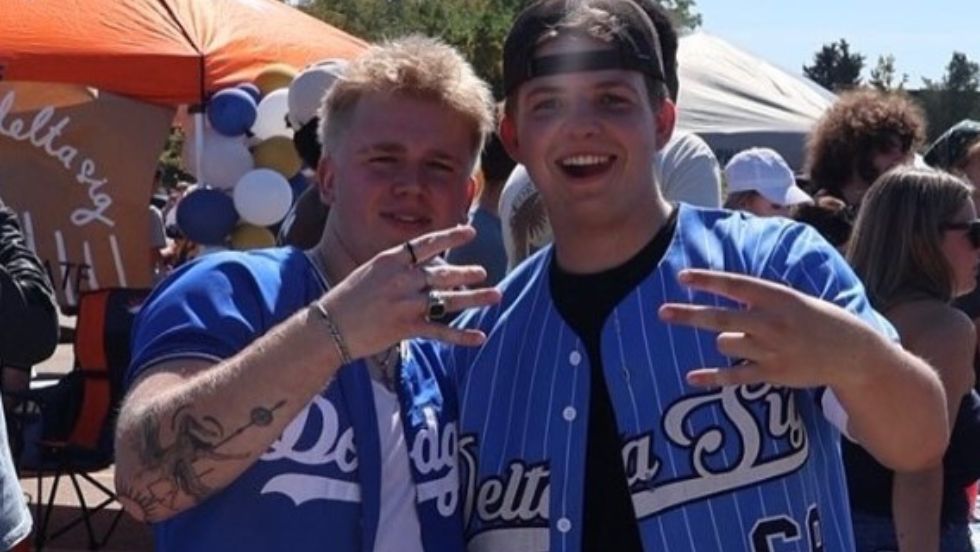 Members of Delta Sig pose for a photo at an outdoor event