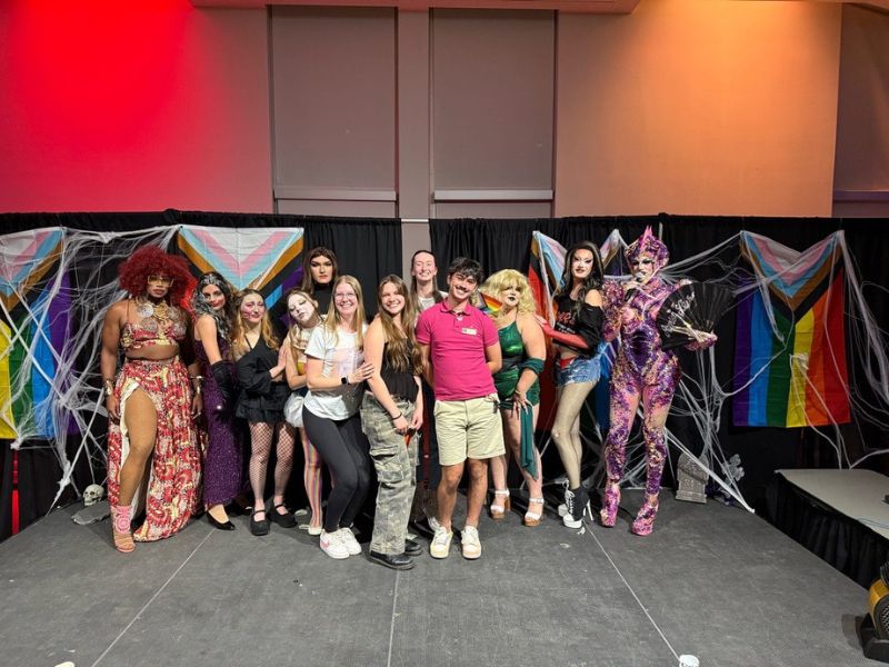 Students pose for a group photo after an event