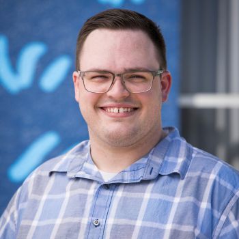 A professional headshot of Riley Sparks