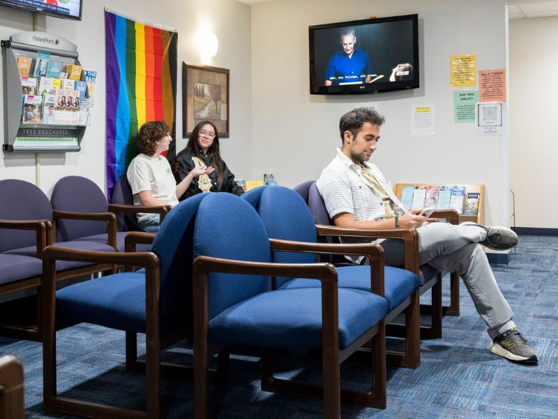 Patients wait for their appointment in the waiting room at the University Health Clinic