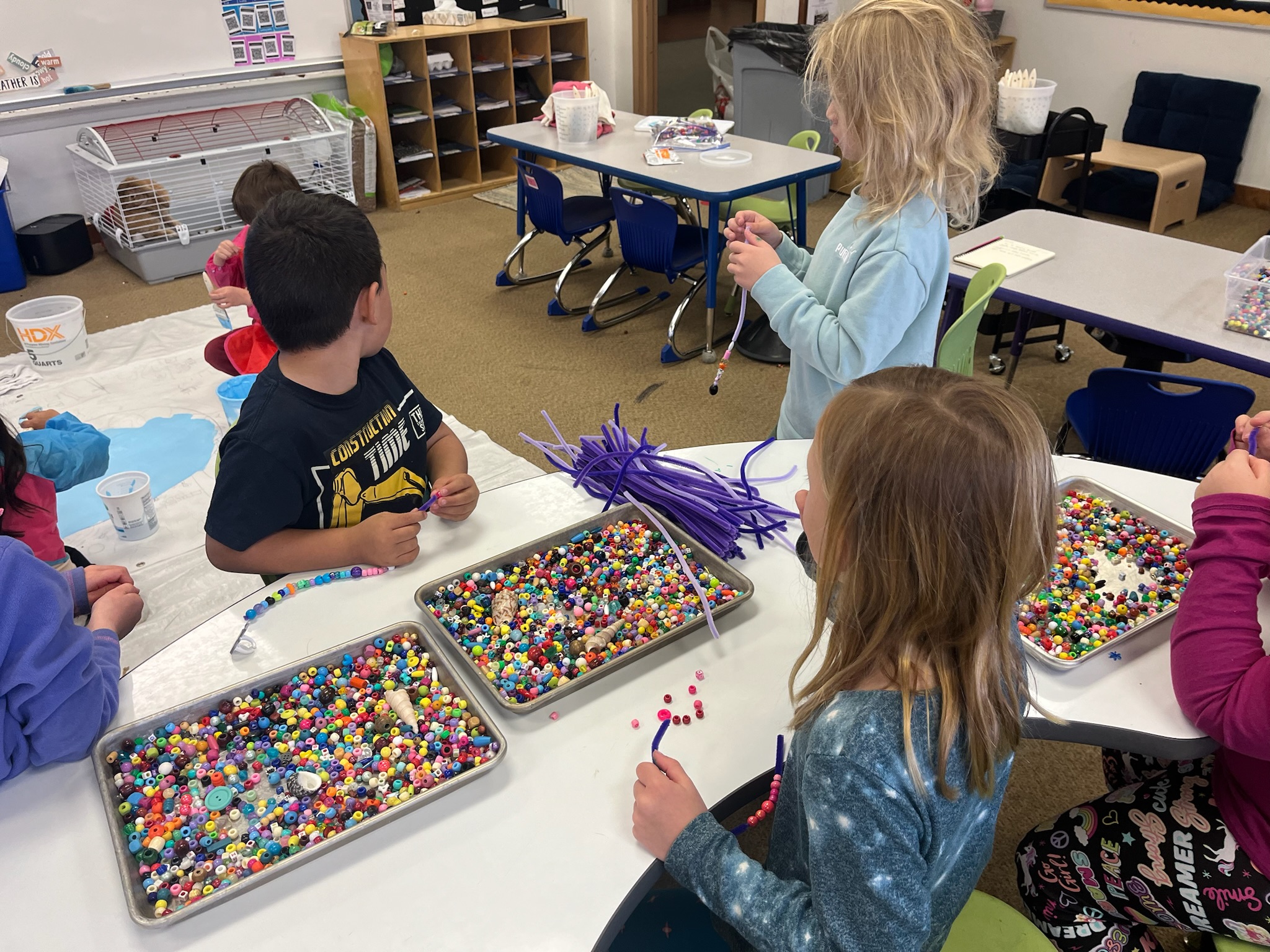 Young students working on a bead project with UNC art education students.