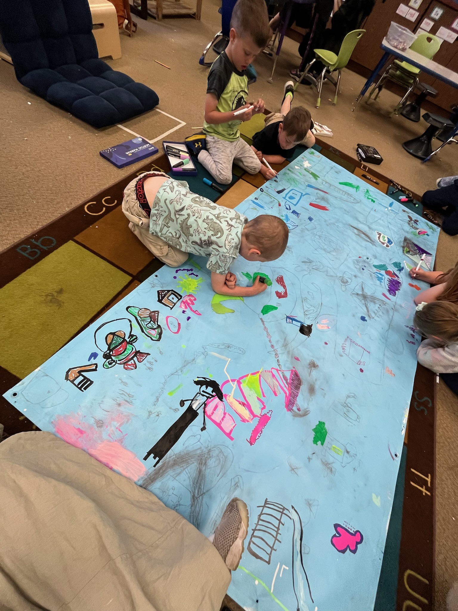 Young students working on a project with art education majors.