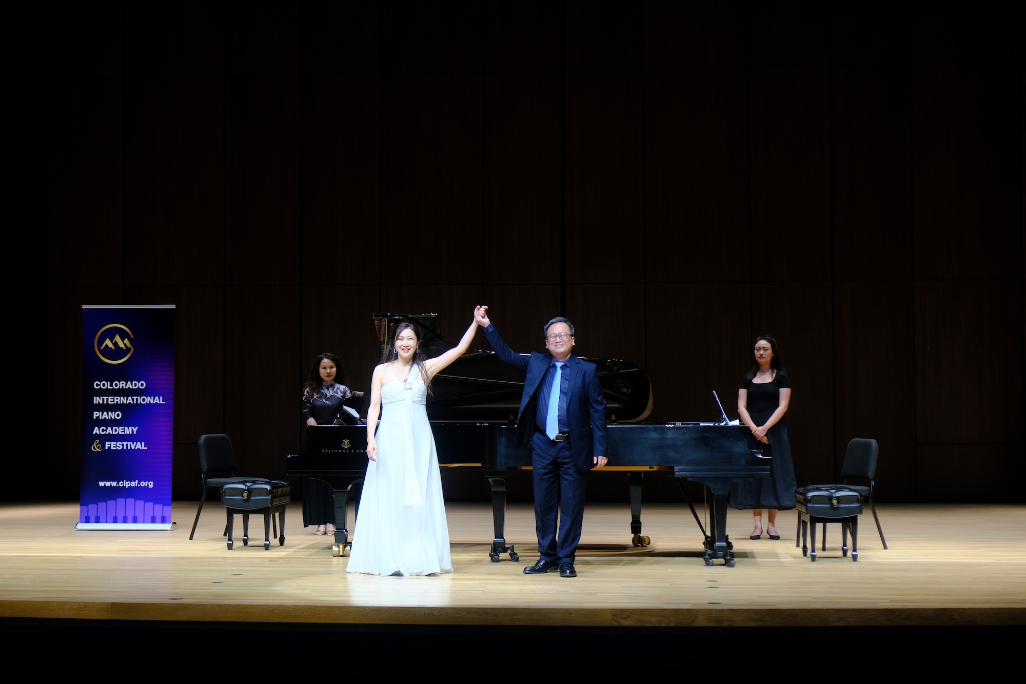 Colorado International Piano Academy and Festival performers acknowledging the audience on stage.