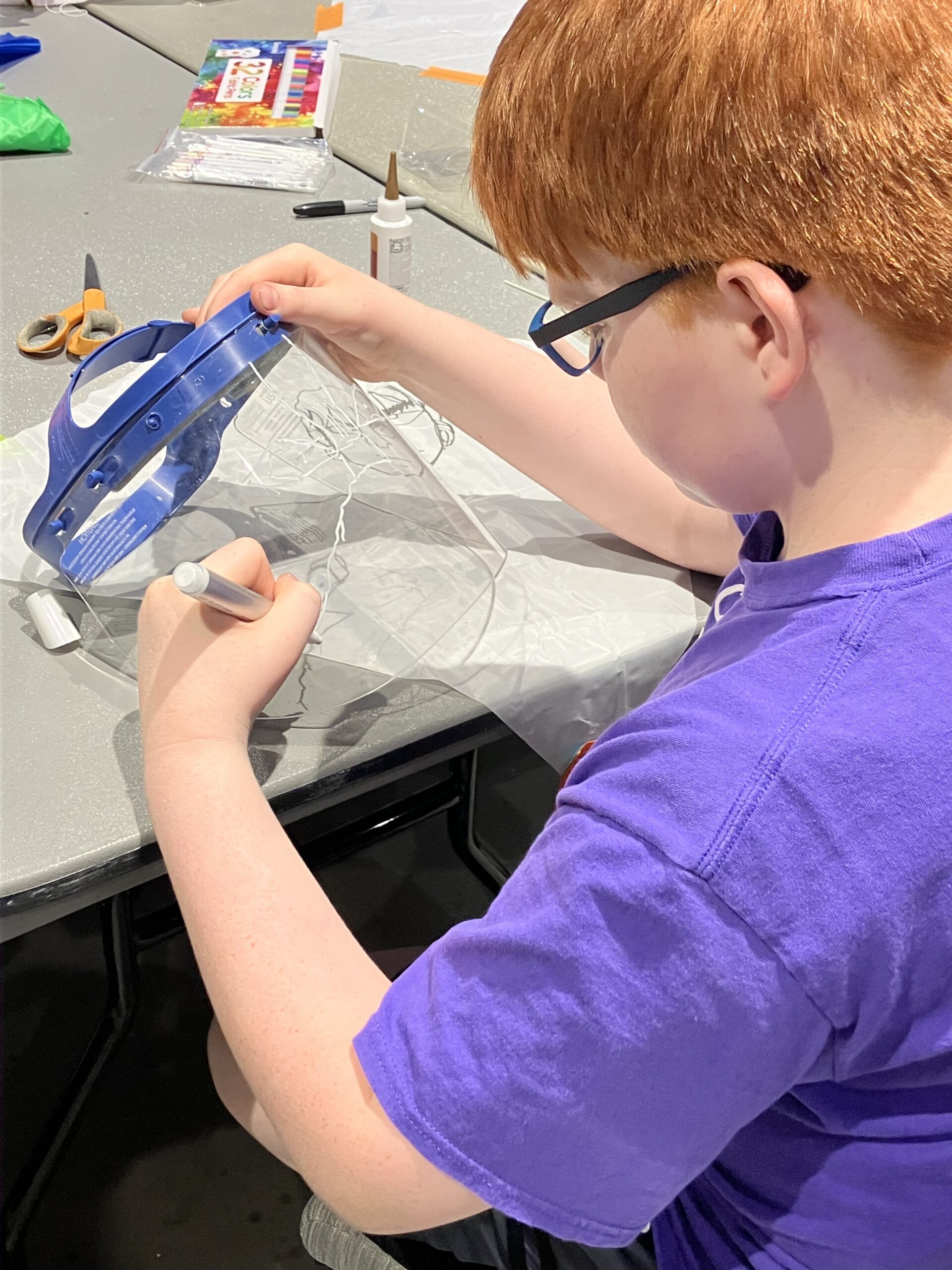 Student creating a mask at Exploring Arts Camp.