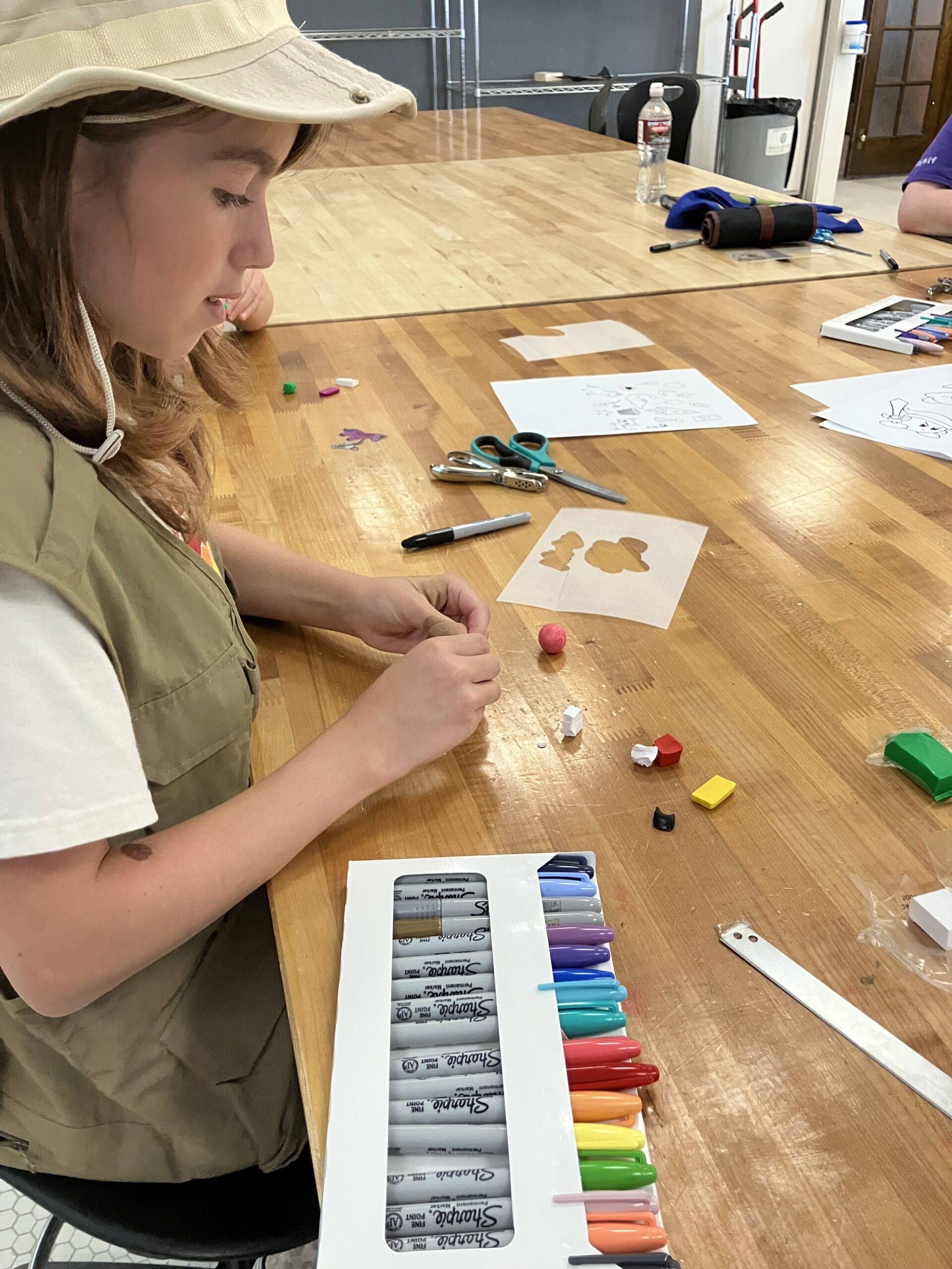 Student making a clay project at Exploring Arts Camp.
