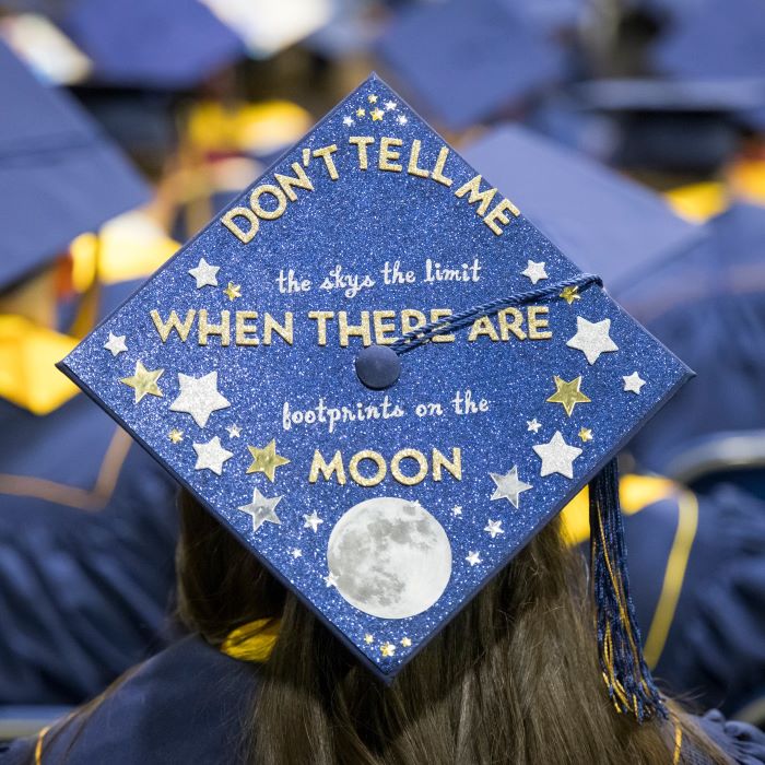 Photo of the back of a student showing their graduation cap.