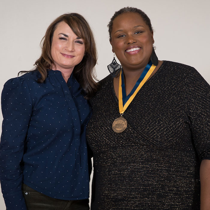 A graduate faculty member standing next to a graduate student who has been awarded a Dean's Citation.