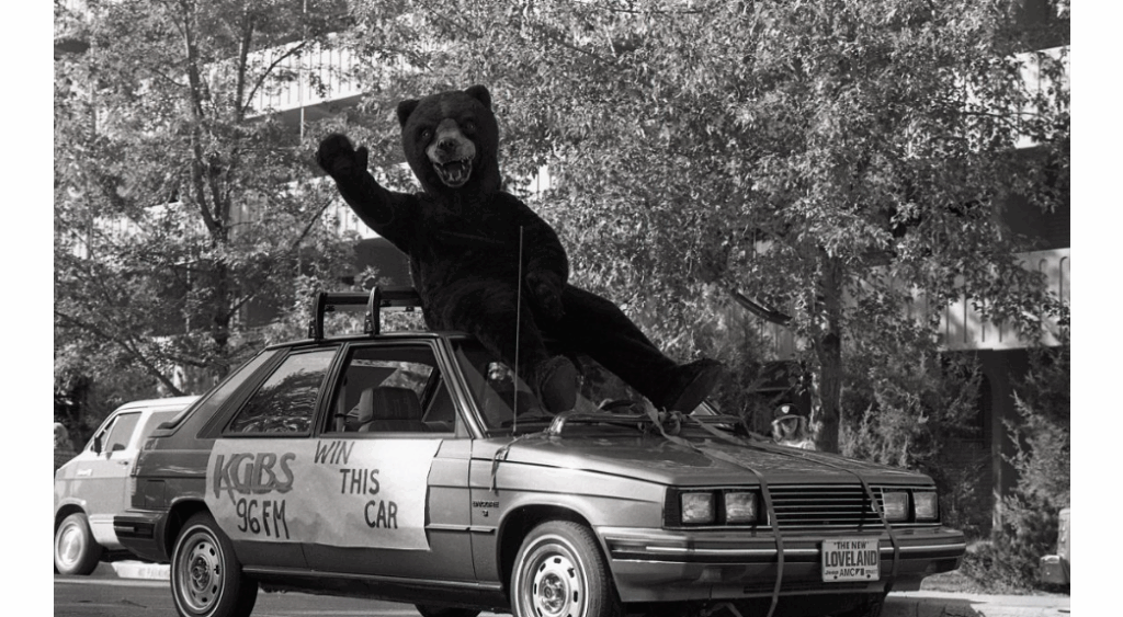 A previous UNC Bear mascot sitting on a car
