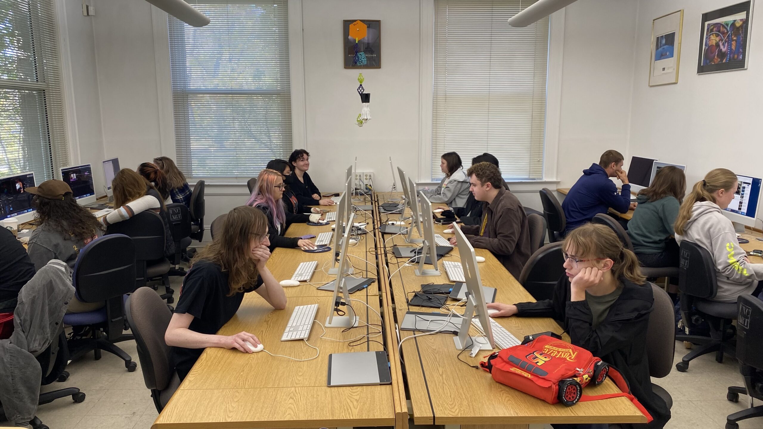 Students working on digital art in a computer classroom.