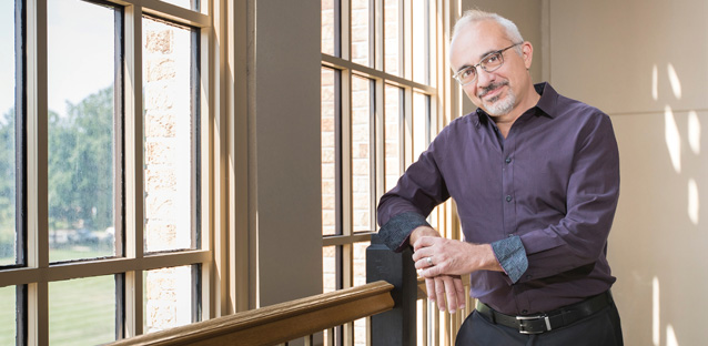 MCB dean Kamel Haddad posing for the camera in front of a window.