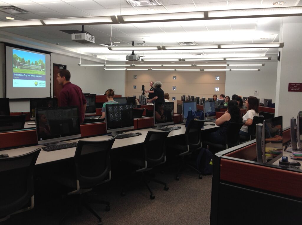 Students in computer lab 303 in Michener Library preparing to watch a presentation