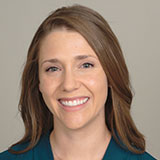 A headshot of Caitlin Raaz smiling