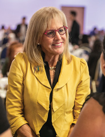 Stryker program founder Ronda Stryker in a yellow suit.