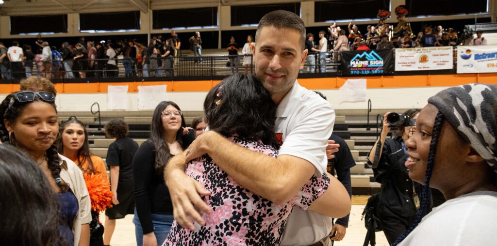 Stephen Paulson hugging someone in celebration of his award