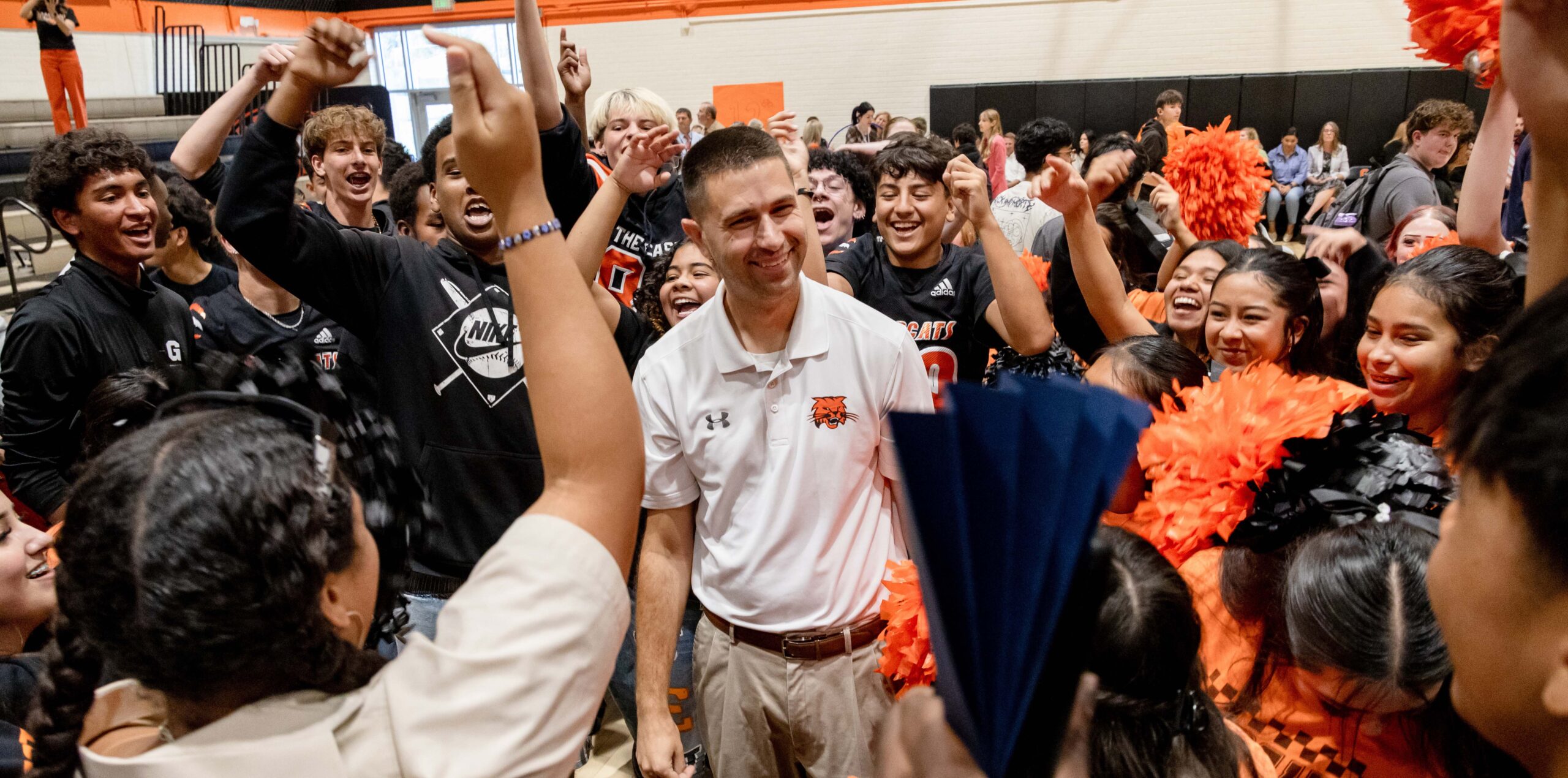 Stephen Paulson surrounded by people cheering for him