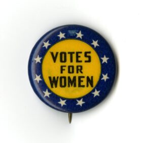 Round blue and yellow button with white stars and the words 