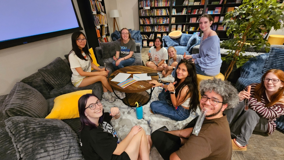 A group of students debriefing during a Praxis Trivia event