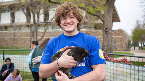 Student holding a rabbit at the homecoming petting zoo in 2025.