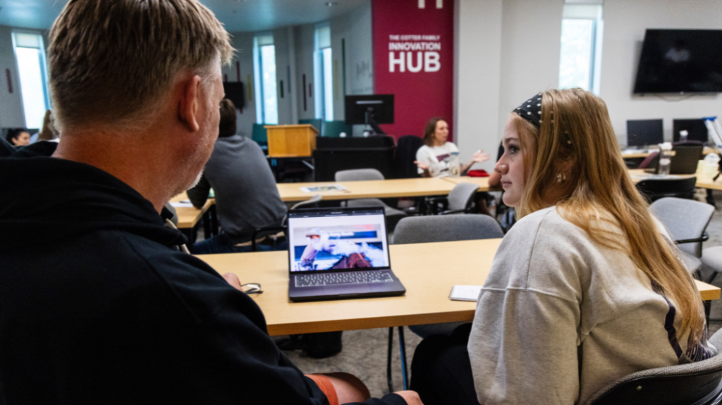 Two people looking at a computer