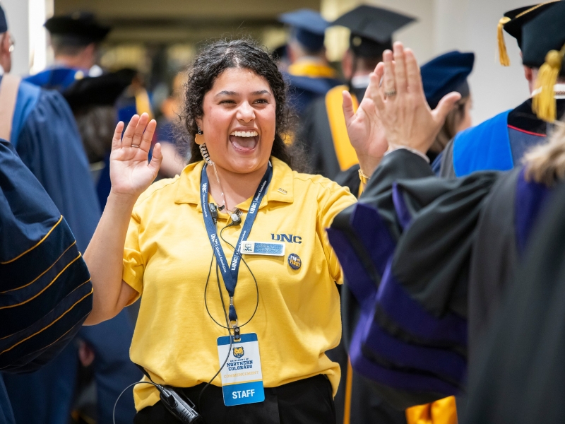 Alum Teresa Castro, '21, MBA, high fiving a grad at Commencement, spring 2026
