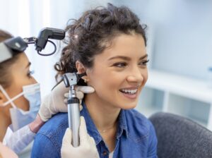 Woman patient during an ear check-up with an audiologist