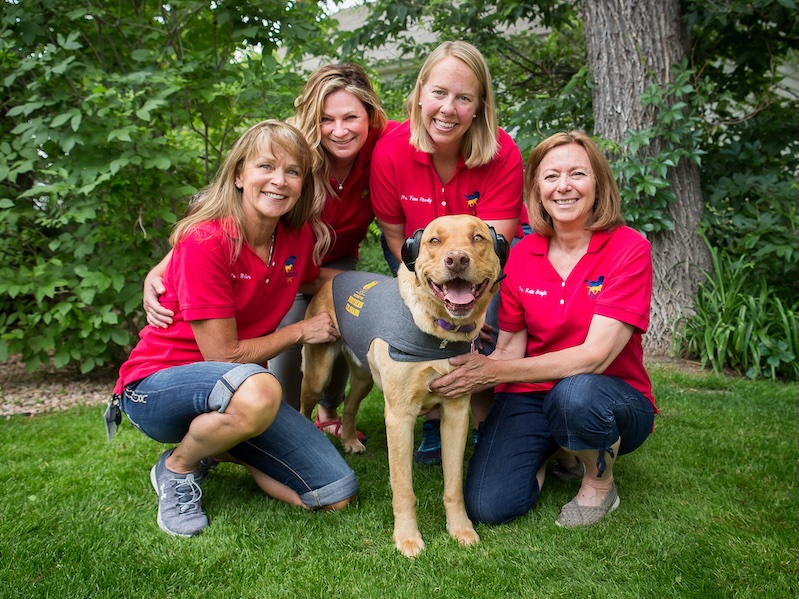 Four women and a dog doing a canine hearing assessment at UNC.