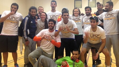 Students huddled together after winning an Intramural Indoor Soccer League
