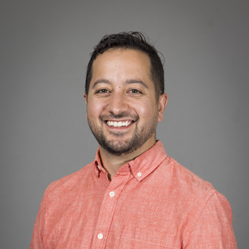 Headshot photo of Michael Mingroni in front of a gray background