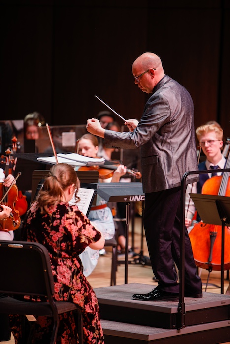 Graduate student conducting at the 2026 opera in bloom gala.