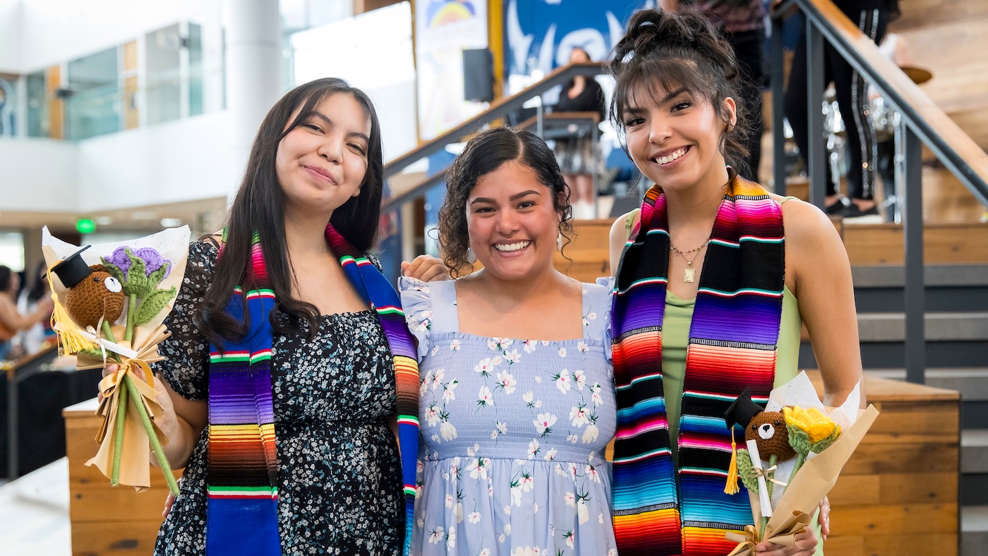 Three Latina women celebrating graduation
