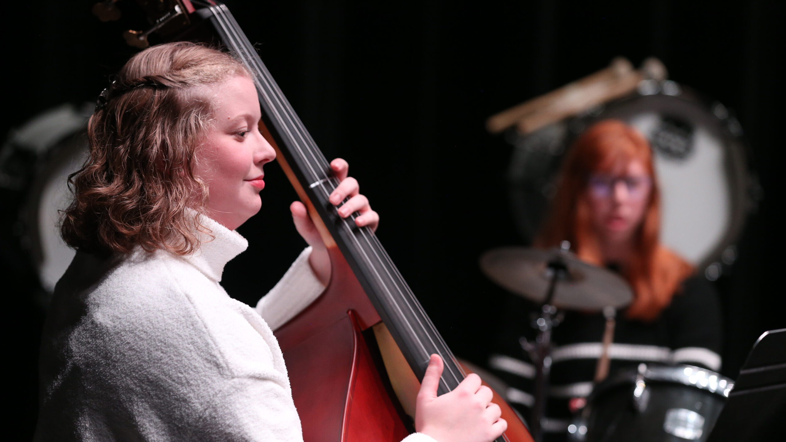 A female musician playing the base