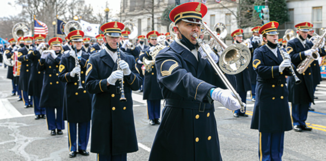 A marching band, including some UNC graduates, performing in full uniform at the Biden/Harris inaugural parade.
