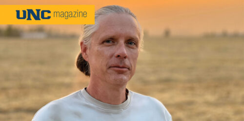 Andy Creekmore looking at the camera in a field