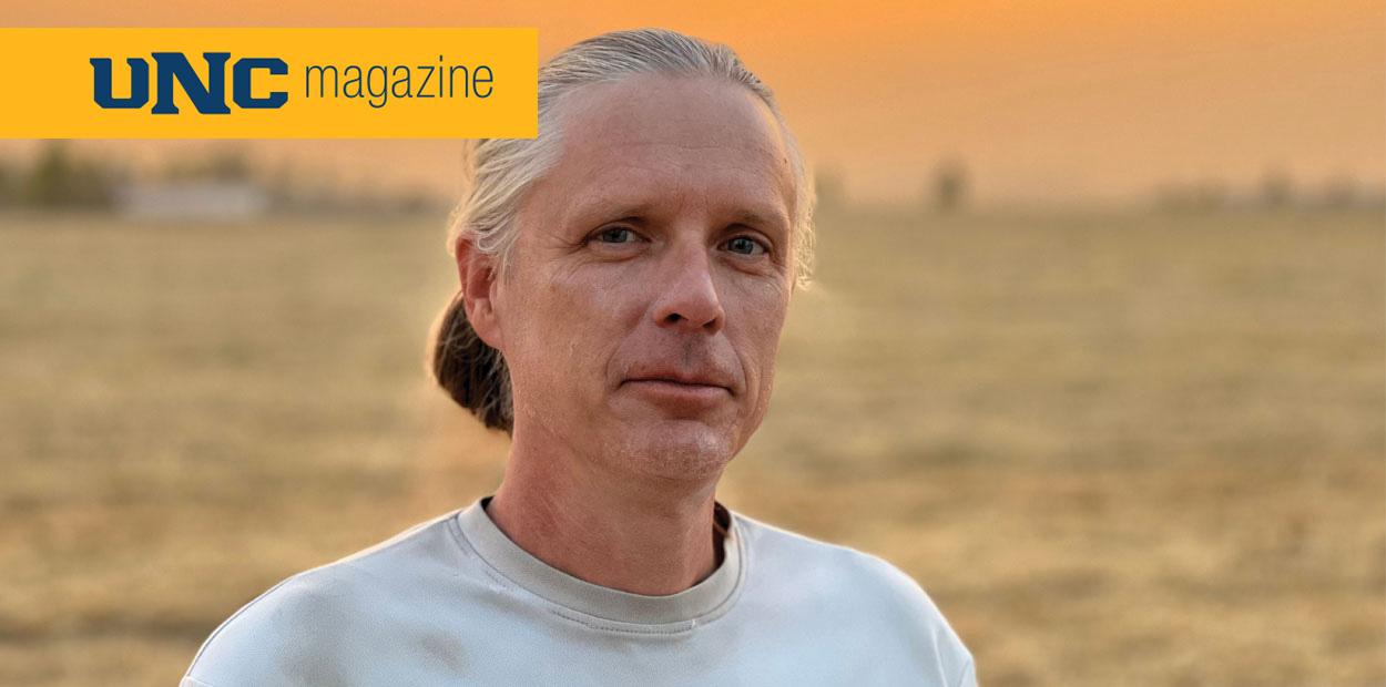 Andy Creekmore looking at the camera in a field