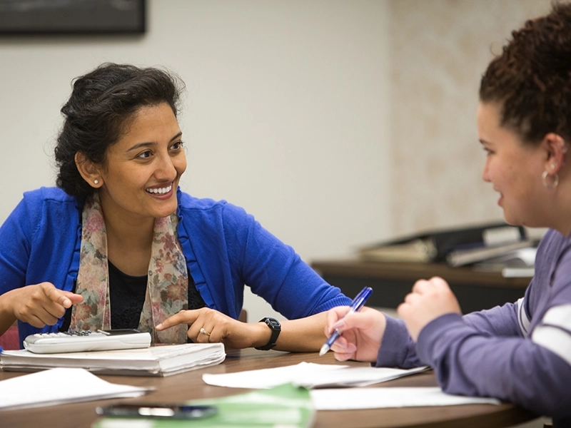 Two graduate students collaborate on a data analysis project in the Applied Statistics and Research Methods program.