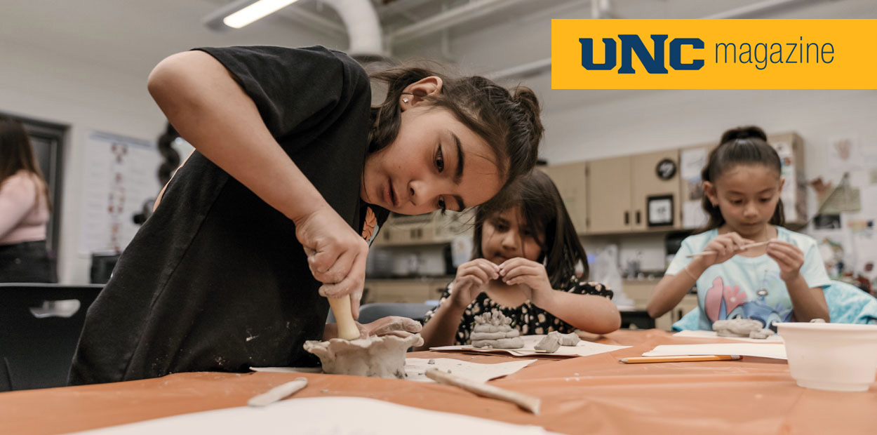 A student making a bowl out of clay